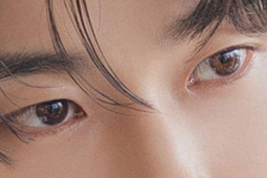 Tampilan close-up sepasang mata dengan rambut hitam yang sedikit menutupi dahi, memperlihatkan detail warna mata cokelat lembut.
