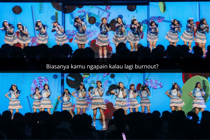 Grup idola perempuan tampil di atas panggung dengan kostum berwarna pastel di depan penonton dan latar layar warna-warni.